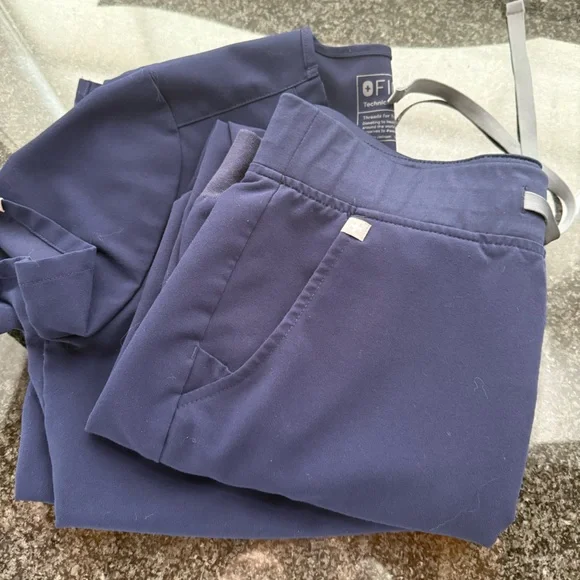 Three sets of FIGS scrubs, black, navy, dark red, size small